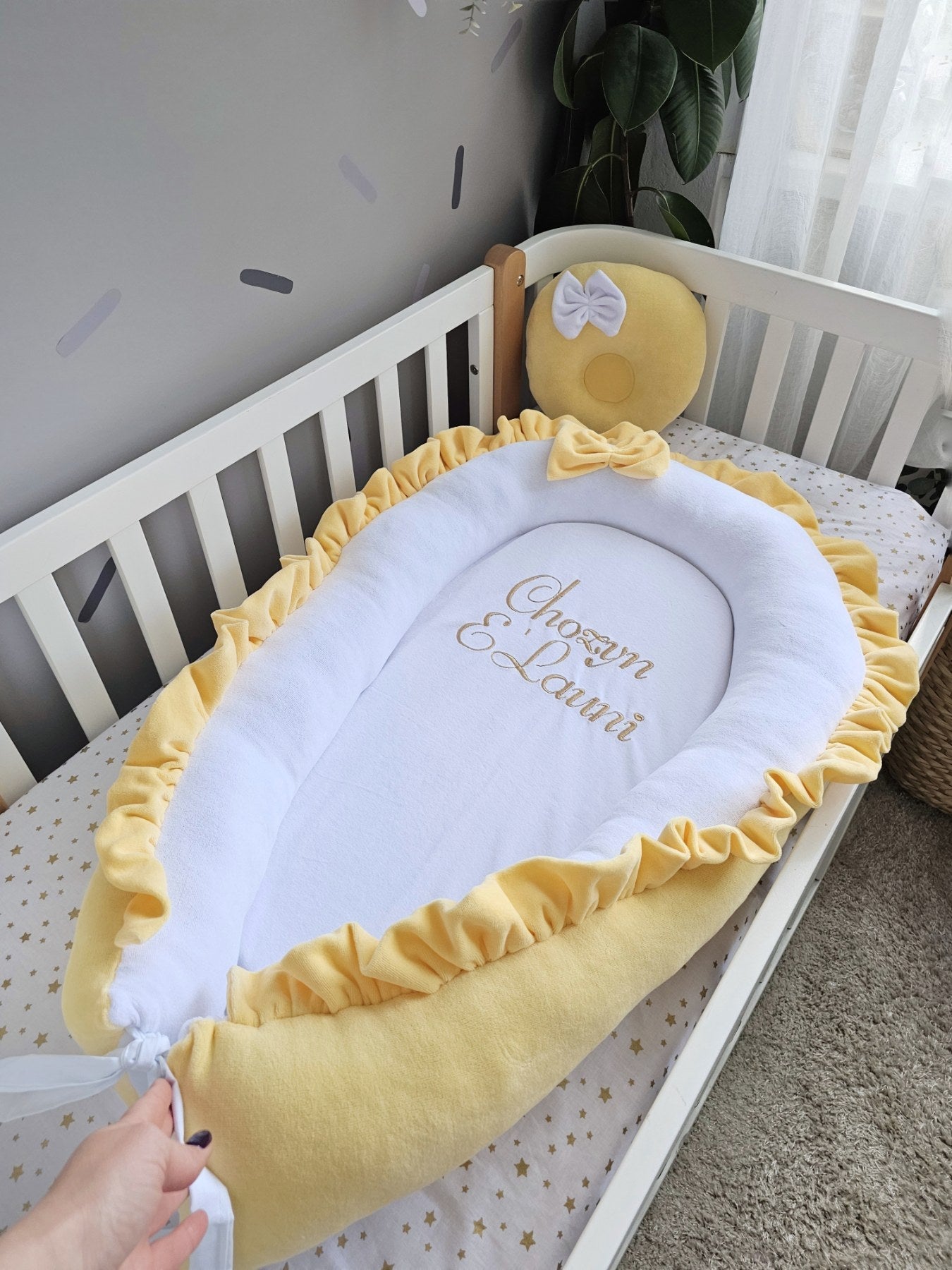 Baby nest with baby name and yellow small pillow. KAR studio